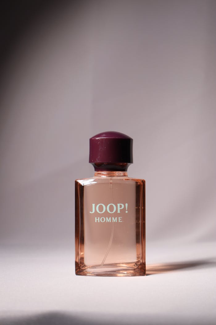 Studio shot of Joop Homme perfume bottle with elegant lighting.
